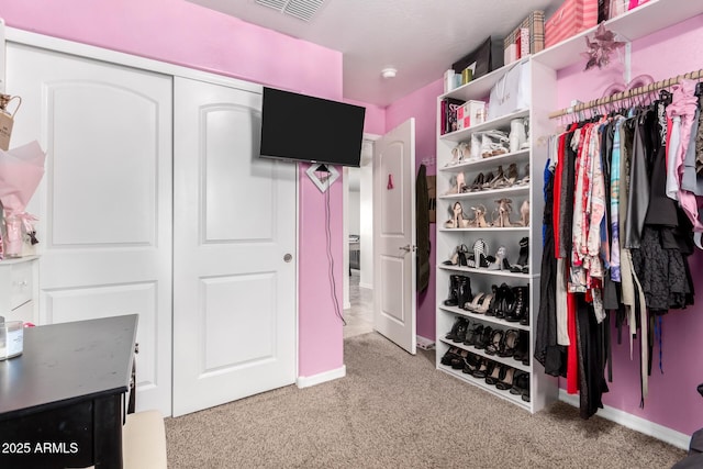 spacious closet with carpet flooring