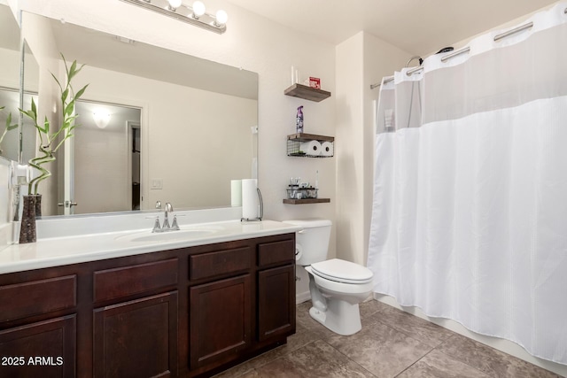 bathroom with vanity, tile patterned floors, and toilet