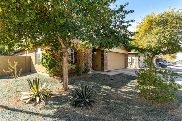 view of property hidden behind natural elements featuring a garage