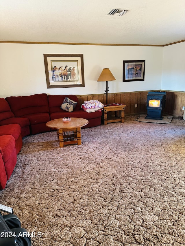 carpeted living room featuring a wood stove and ornamental molding