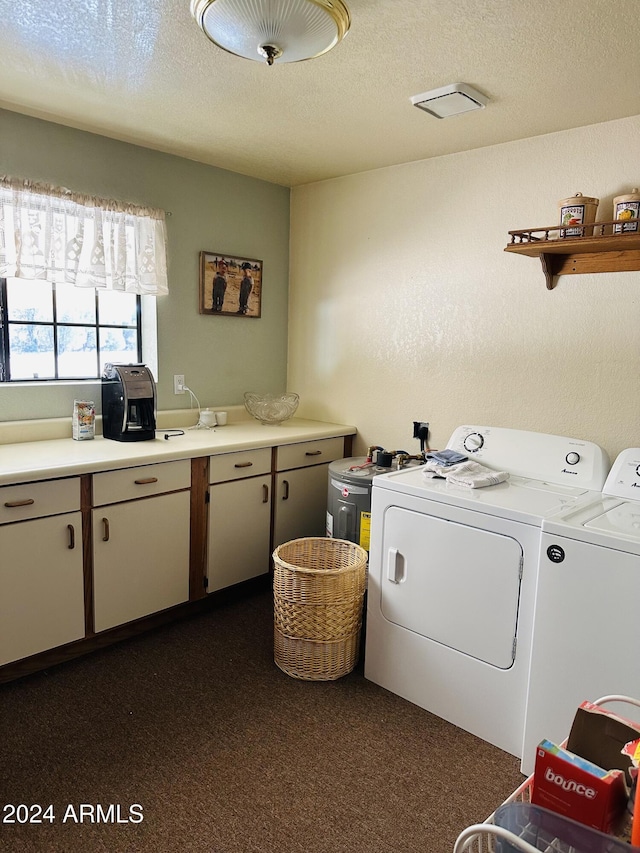 laundry room featuring washer and dryer, a textured ceiling, and cabinets