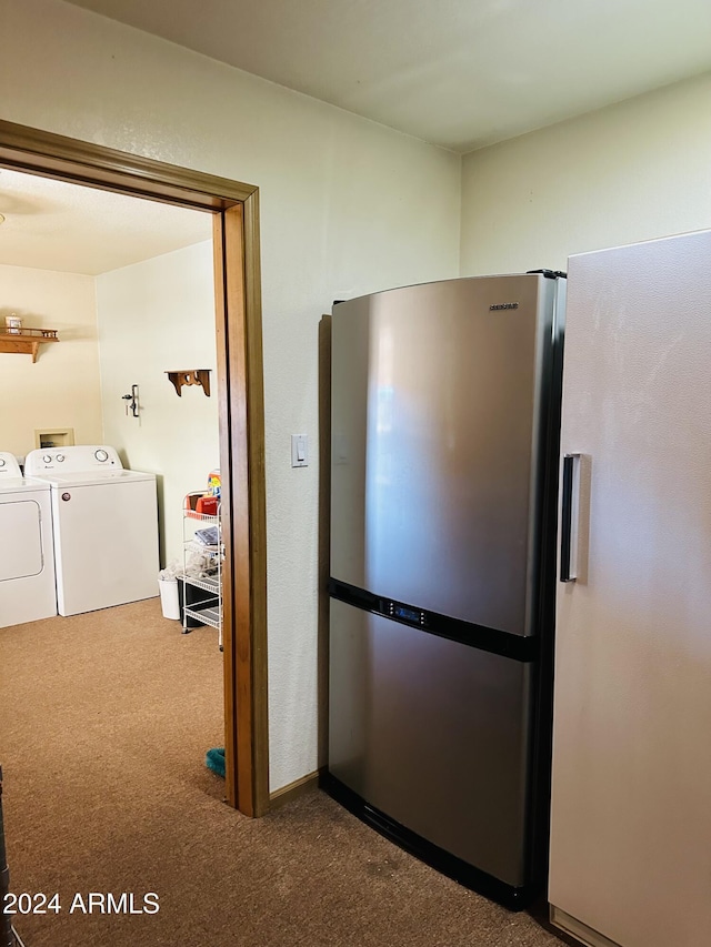 kitchen featuring stainless steel refrigerator with ice dispenser, carpet floors, stainless steel refrigerator, and washer and clothes dryer