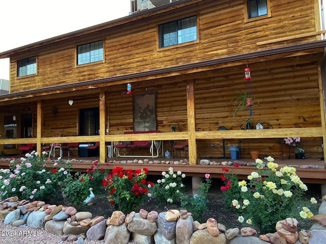 rear view of house featuring a porch