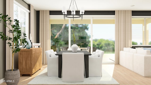 dining space featuring light wood-style floors and a notable chandelier