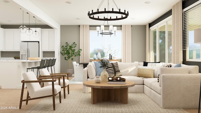 living area featuring a notable chandelier and light wood-style flooring