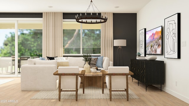 living area featuring hardwood / wood-style flooring, an inviting chandelier, a healthy amount of sunlight, and baseboards
