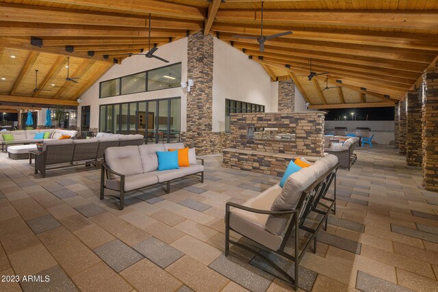 view of patio with an outdoor living space with a fireplace and ceiling fan