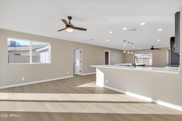 7607 N 42nd Ln, Phoenix, AZ 85051 - spare room with ceiling fan, a sink, light wood finished floors, baseboards, and recessed lighting
