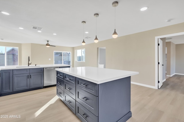 7607 N 42nd Ln, Phoenix, AZ 85051 - kitchen with dishwasher, a sink, light wood-style floors, light countertops, and a ceiling fan