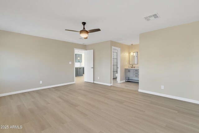 7607 N 42nd Ln, Phoenix, AZ 85051 - unfurnished bedroom featuring light wood-style flooring, connected bathroom, baseboards, and a ceiling fan