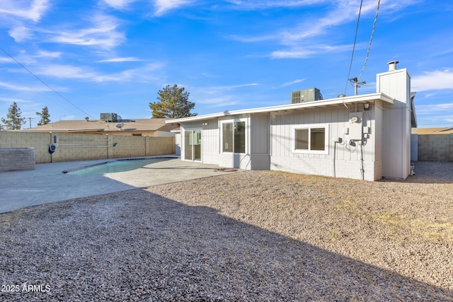 7607 N 42nd Ln, Phoenix, AZ 85051 - rear view of property featuring a chimney, a fenced backyard, a patio area, and concrete block siding