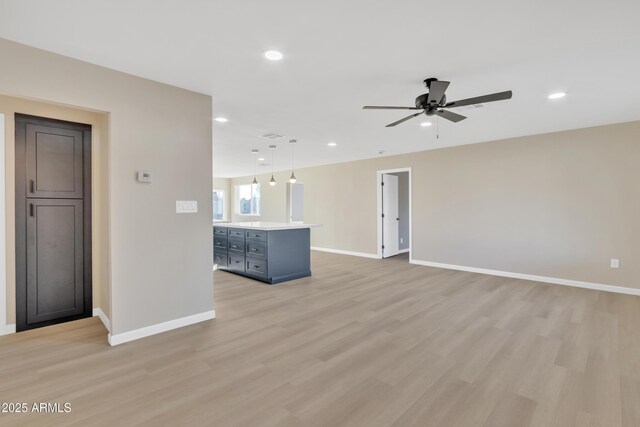 7607 N 42nd Ln, Phoenix, AZ 85051 - unfurnished living room with a ceiling fan, light wood-style flooring, baseboards, and recessed lighting