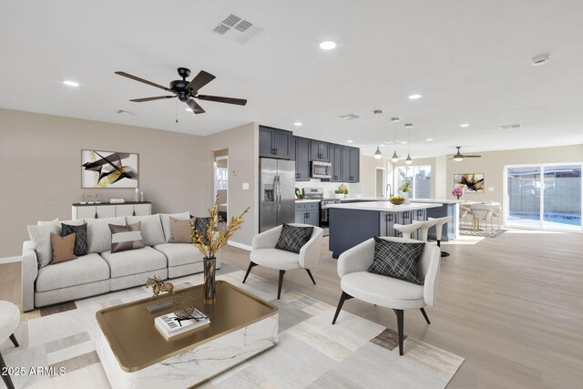 7607 N 42nd Ln, Phoenix, AZ 85051 - living area featuring ceiling fan, light wood-style floors, recessed lighting, and baseboards