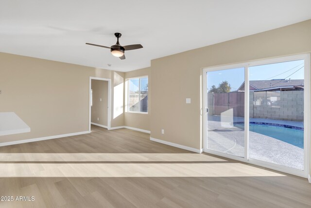 7607 N 42nd Ln, Phoenix, AZ 85051 - unfurnished room featuring wood finished floors, healthy amount of natural light, baseboards, and a ceiling fan