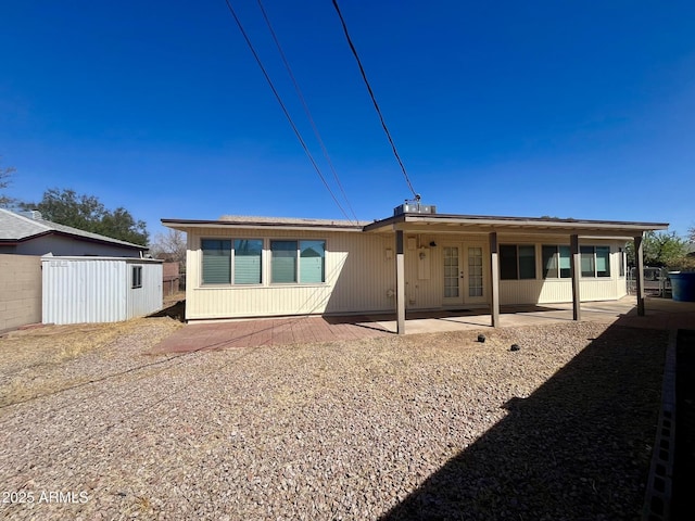 back of property with a patio and french doors