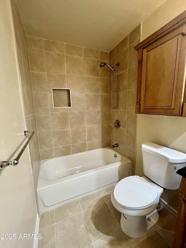 full bath featuring washtub / shower combination, toilet, and tile patterned floors