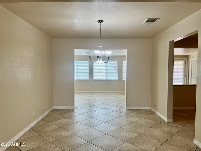 unfurnished dining area with baseboards, light tile patterned flooring, visible vents, and an inviting chandelier