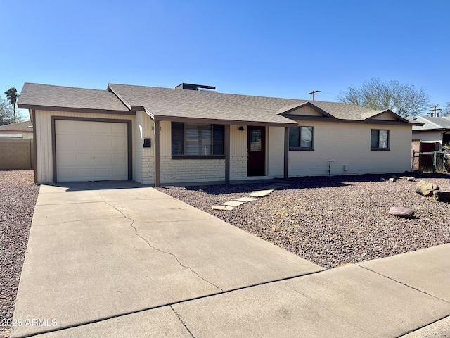 ranch-style house featuring an attached garage, brick siding, a shingled roof, fence, and concrete driveway