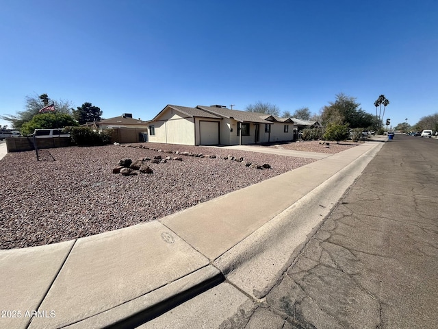 view of front of property featuring a garage and fence