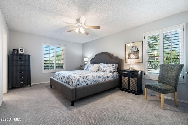 carpeted bedroom with ceiling fan and a textured ceiling