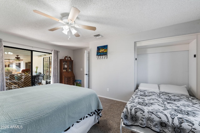 carpeted bedroom with ceiling fan, access to exterior, and a textured ceiling