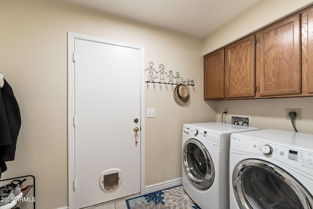 laundry room featuring cabinets, washer and dryer, and light tile patterned floors