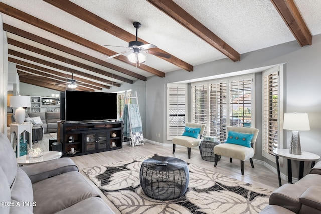 living room with lofted ceiling with beams, ceiling fan, light hardwood / wood-style floors, and a textured ceiling