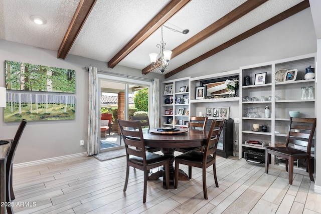 dining space featuring vaulted ceiling with beams, a textured ceiling, and a chandelier