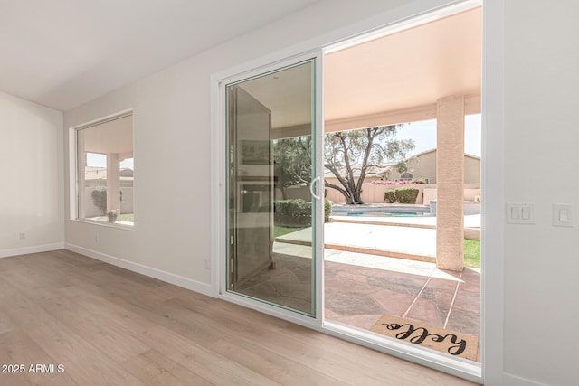 4010 N 156th Ln, Goodyear, AZ 85395 - doorway to outside with a wealth of natural light, wood finished floors, and baseboards
