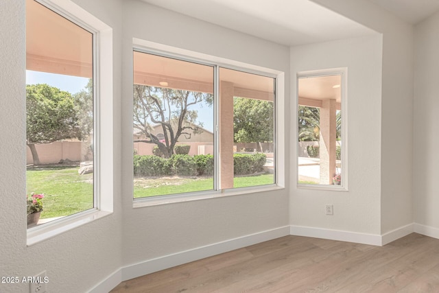 4010 N 156th Ln, Goodyear, AZ 85395 - spare room with light wood-style flooring, a textured wall, and baseboards