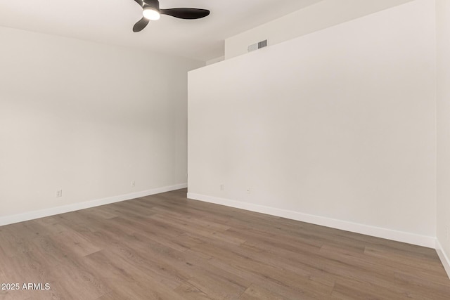 4010 N 156th Ln, Goodyear, AZ 85395 - spare room featuring wood finished floors, baseboards, a ceiling fan, and visible vents