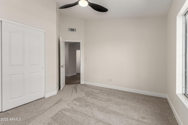 4010 N 156th Ln, Goodyear, AZ 85395 - unfurnished bedroom featuring visible vents, baseboards, carpet flooring, and ceiling fan