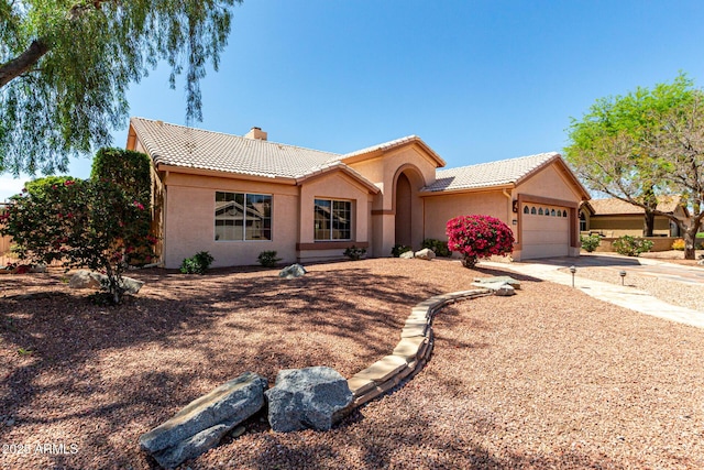4010 N 156th Ln, Goodyear, AZ 85395 - ranch-style home featuring concrete driveway, stucco siding, a chimney, an attached garage, and a tiled roof