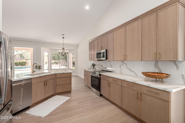 4010 N 156th Ln, Goodyear, AZ 85395 - kitchen with a sink, light wood finished floors, light brown cabinetry, and stainless steel appliances