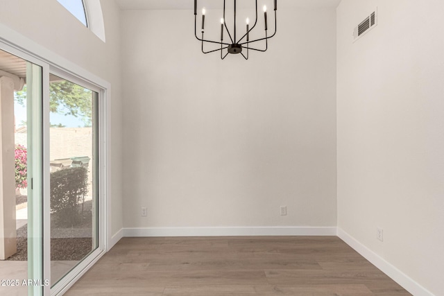 4010 N 156th Ln, Goodyear, AZ 85395 - unfurnished dining area featuring light wood-type flooring, an inviting chandelier, baseboards, and visible vents