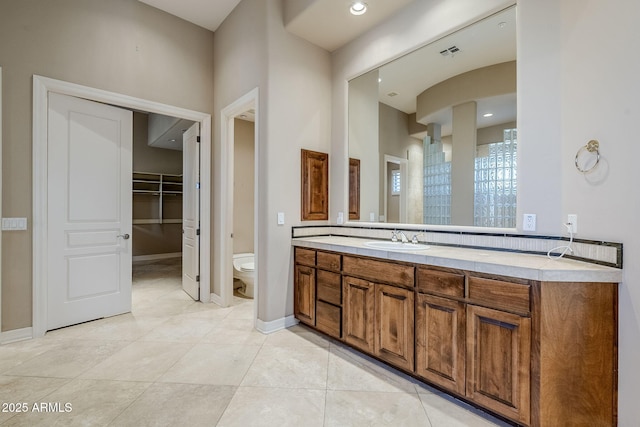 bathroom featuring tile patterned floors, toilet, and vanity