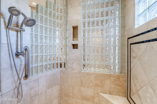 bathroom with a tile shower