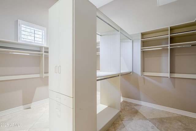 spacious closet featuring light tile patterned flooring