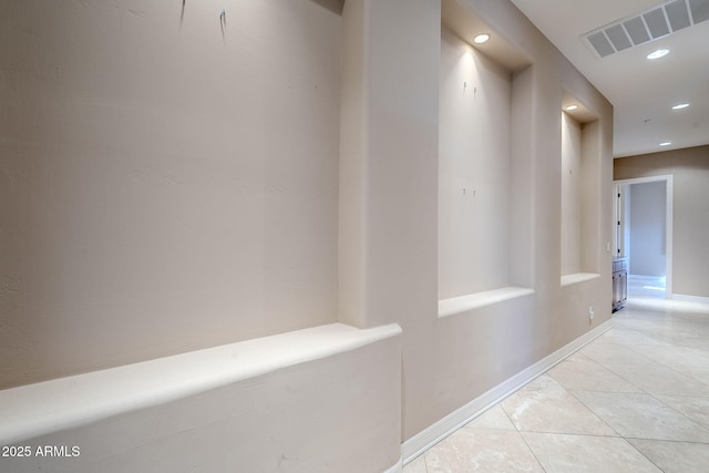 corridor with light tile patterned flooring