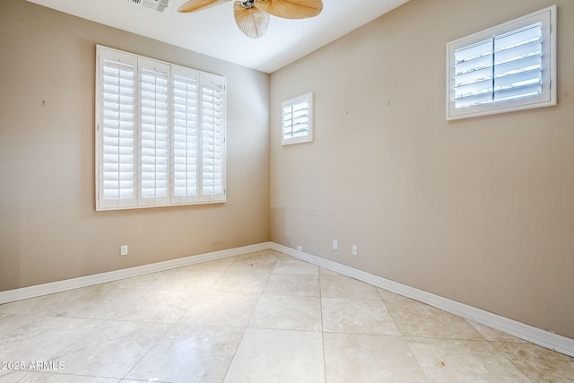 empty room with light tile patterned floors and ceiling fan