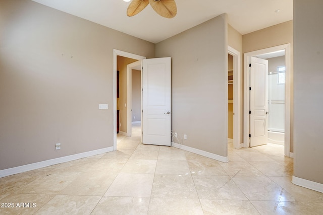 unfurnished bedroom with light tile patterned flooring, ceiling fan, and ensuite bath