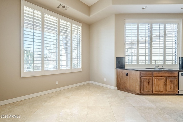 kitchen featuring light tile patterned flooring, dishwasher, and sink