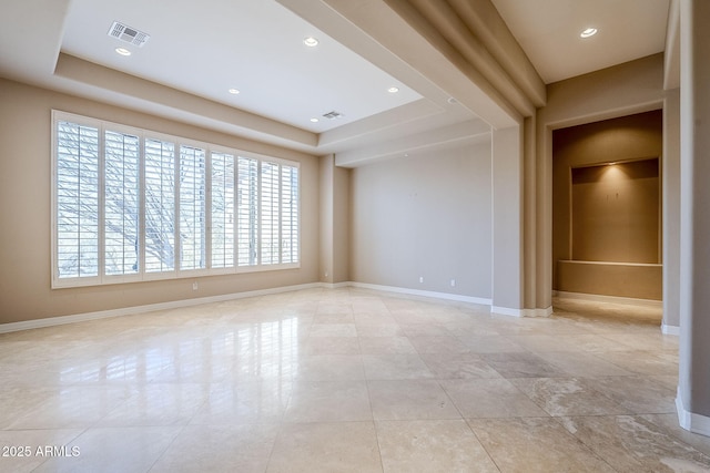 empty room with a raised ceiling