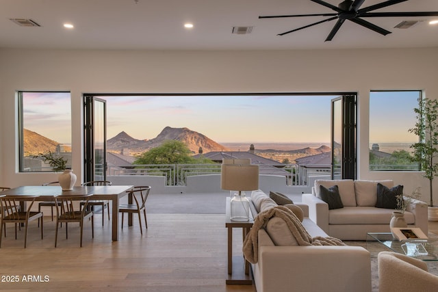 13631 E Windrose Dr, Scottsdale, AZ 85259 - living area featuring light wood-style flooring, a mountain view, a ceiling fan, and recessed lighting