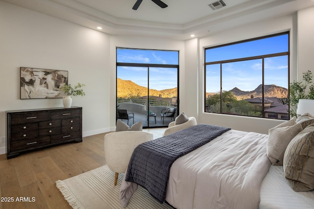 13631 E Windrose Dr, Scottsdale, AZ 85259 - bedroom featuring access to outside, a mountain view, hardwood / wood-style flooring, baseboards, and a ceiling fan