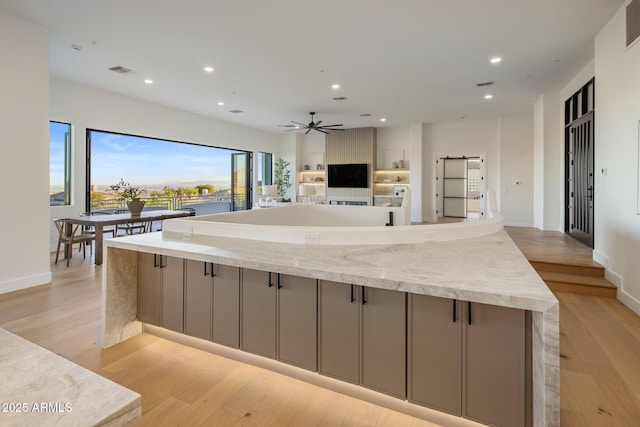 13631 E Windrose Dr, Scottsdale, AZ 85259 - kitchen featuring gray cabinetry, recessed lighting, light wood-style flooring, a large island, and a barn door