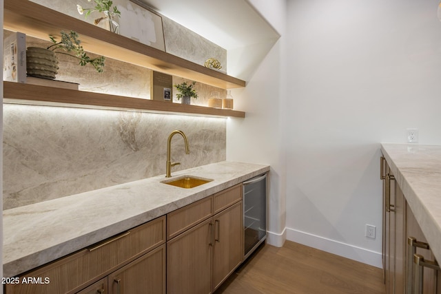13631 E Windrose Dr, Scottsdale, AZ 85259 - indoor wet bar featuring baseboards, light wood-style floors, wine cooler, and backsplash
