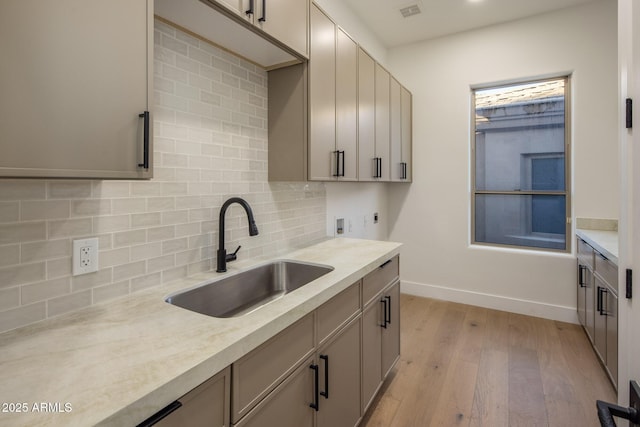 13631 E Windrose Dr, Scottsdale, AZ 85259 - kitchen featuring a sink, light wood finished floors, and light countertops