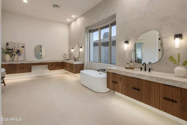 13631 E Windrose Dr, Scottsdale, AZ 85259 - bathroom with two vanities, a soaking tub, and recessed lighting