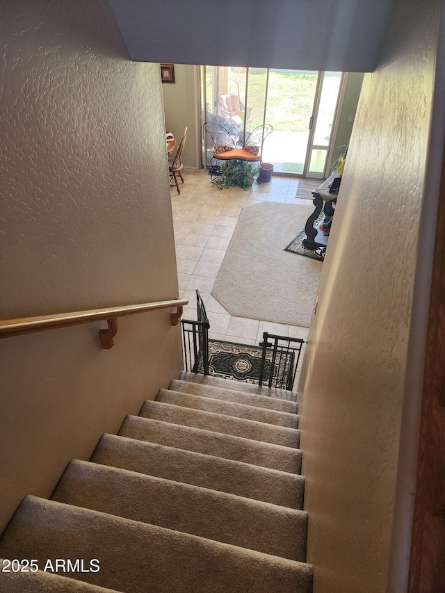 staircase featuring tile patterned flooring